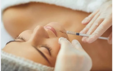 woman getting botox on her chin