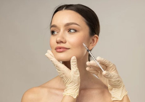 women with head turned as filler is injected